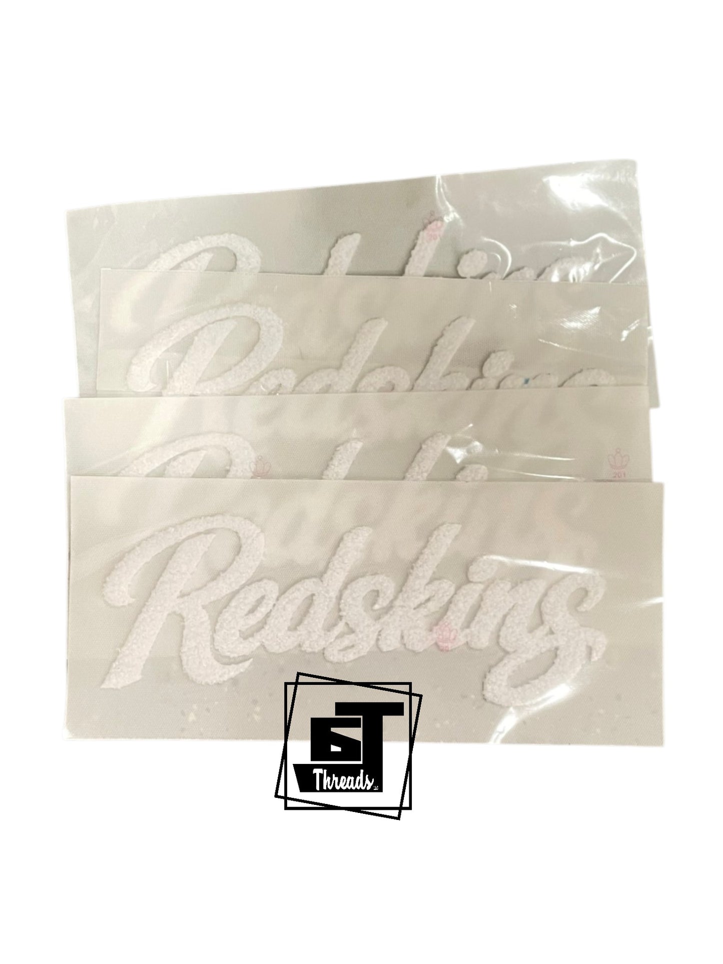 Packaged stickers with 'Redskins' text on a white background