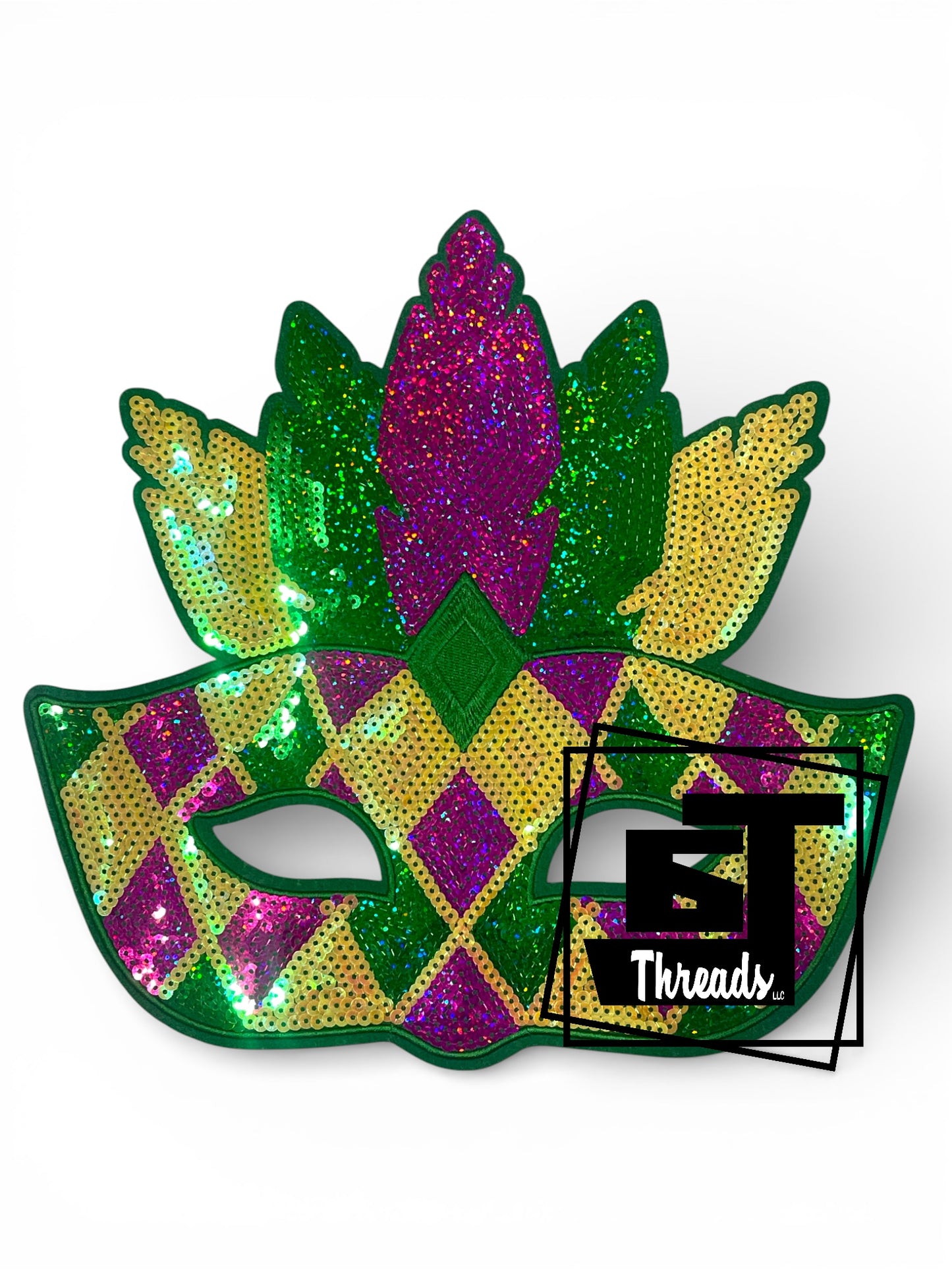 Colorful sequin mask with green, purple, and yellow patterns on a white background