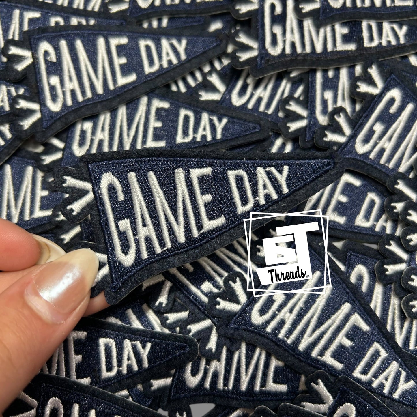 navy 'GAME DAY' patches with a hand holding one patch, branded 'Threads' logo.