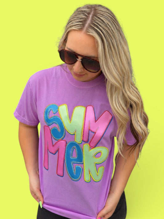 Person wearing a purple t-shirt with colorful 'SUMMER' text on a bright yellow background