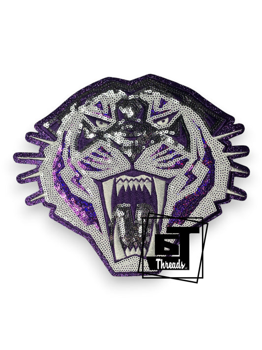 Measurements: 9 inches wide by 7.5 inches tall
Purple and silver sequin tiger head with purple embroidery and purple glitter background
Iron-on Patch