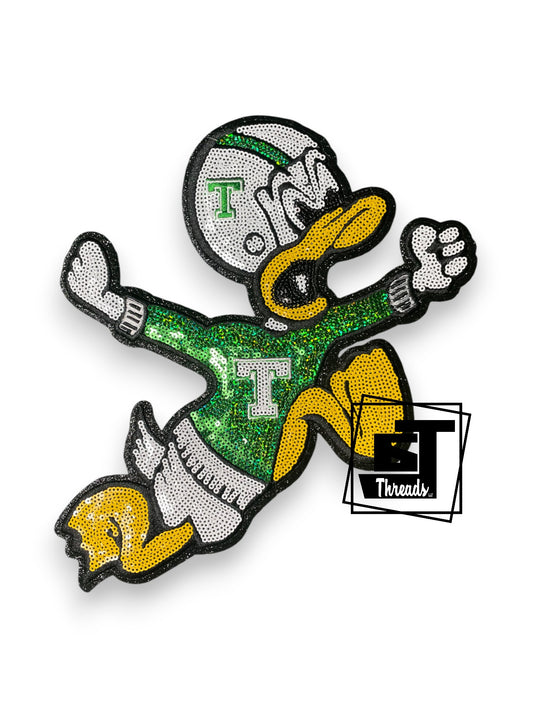 Measurements: 9 inches wide by 11 inches tall
Green, white, and yellow sequin duck mascot with black embroidery and bacl glitter background
Iron-on Patch