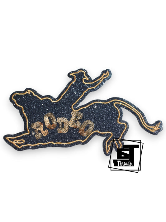Measurements: 6.5 inches wide and 4 inches tall
Black and gold black glitter fabric patch with gold embroidery and gold sequin rodeo
Iron-on Patch