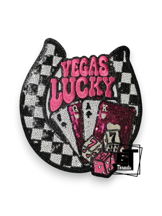 Measurements: 7.5 inches wide by 8 inches tall
Pink checkered sequin Vegas Lucky Horseshoe with checkered sequin and pink embordiered lettering and black glitter background with a card deck
Iron-on Patch