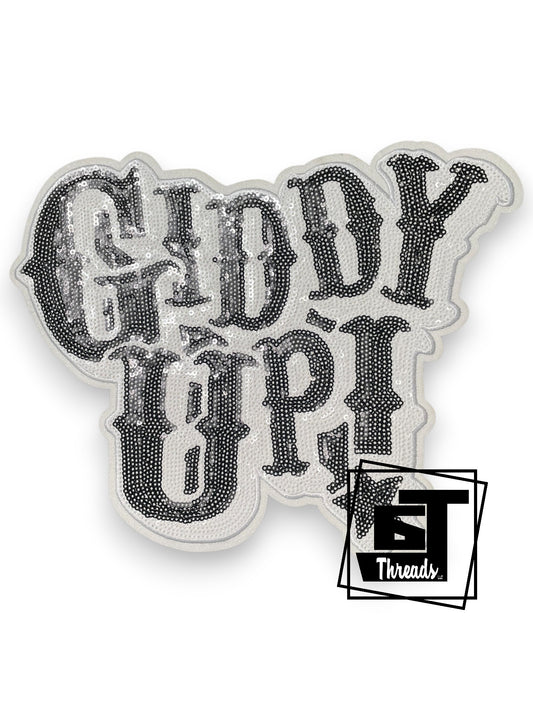 Measurements 10 inches wide by 8 inches tall
Black and white sequin Giddy Up western patch with white embroidery and white glitter background
Iron-on Patch