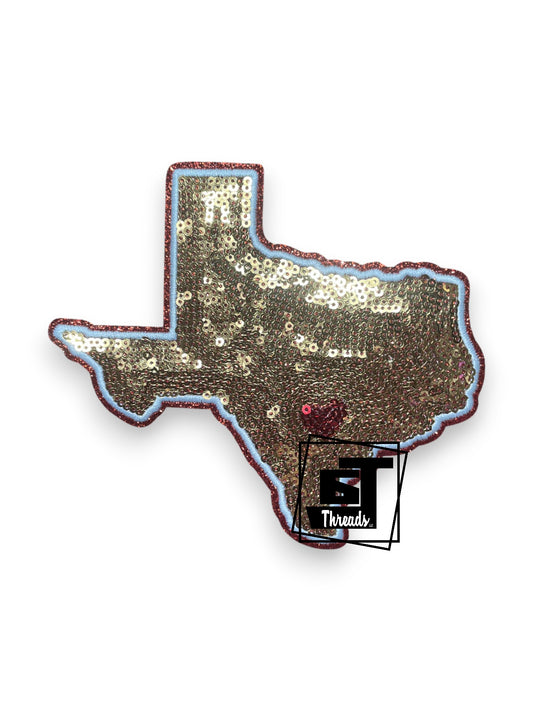Measurements: 5.5 inches wide by 5 inches tall
Gold sequin texas patch with white embroidery and orange glitter background
Iron-on Patch