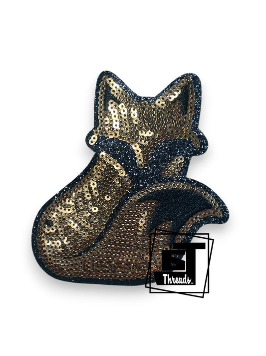 Measurements: 4 inches wide by 4 inches tall
Gold sequin fox patch with black embordiery and black glitter background
Iron-on Patch