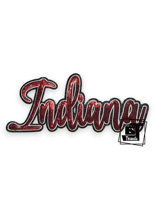 Measurements: 11.5 inches wide by 5.5 inches tall
Red sequin cursive Indiana patch with white embroidery with black glitter background
Iron-on Patch