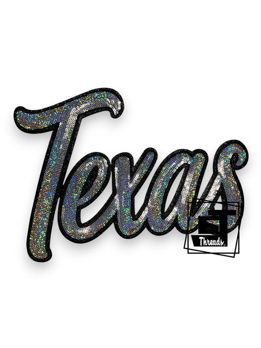 Measurements: 11 inches wide by 8 inches tall
Silver Cursive Sequin Texas with black embroidery and black glitter background