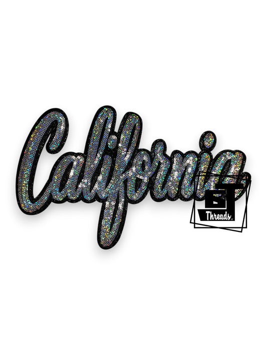 Measurements: 12 inches wide by 7 inches tall
Silver Cursive Sequin California with black embroidery and black glitter background
Iron-on patch