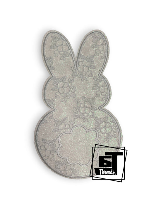 Measurements 6 inches wide by 10.5 inches tal&nbsp;
Whtie glitter fabric bunny with white embroidered flowers and other details with white glitter background
Iron- on Patch