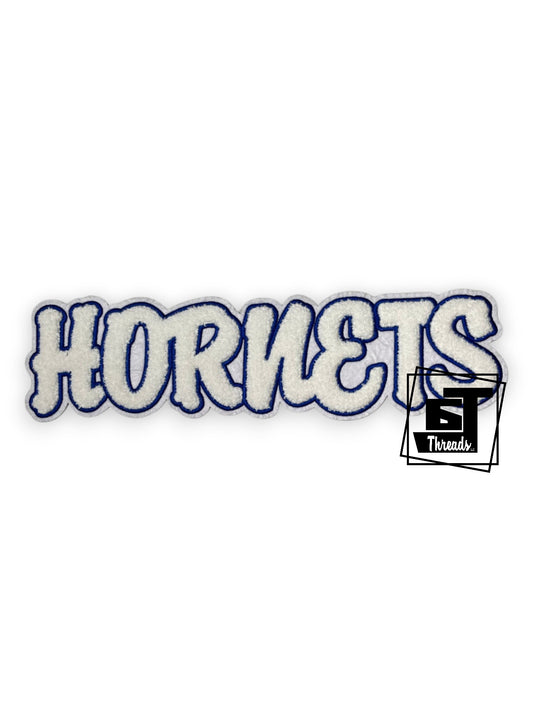 Measurements: 12 inches wide by 3 inches tall
White chenille Hornets with blue embroidery and a white fabric background
Iron-on Patch