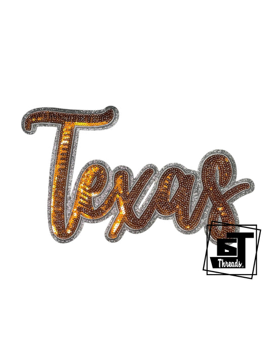 Measurements: 9.5 inches wide by 6 inches tall
Orange cursive sequin Texas patch with silver embroidery and silver glitter background
Iron-on Patch