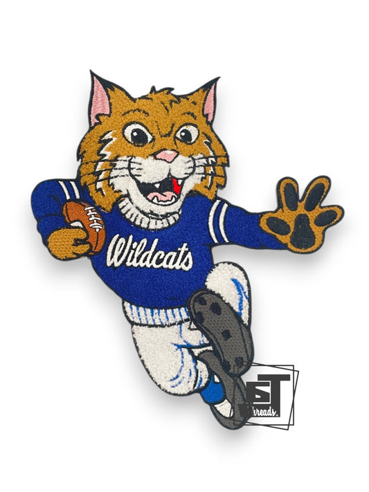 Embroidered patch of a bobcat mascot in a football uniform with 'Wildcats' text on a white background.