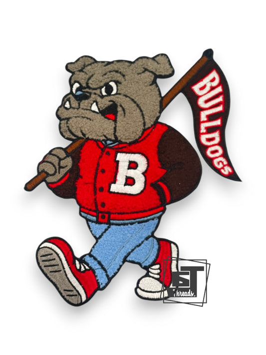 Bulldog mascot in a red jacket with a 'B' holding a flag with 'Bulldogs' text on a white background.