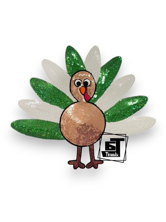 Decorative brooch with a turkey design and green leaves on a white background, featuring the brand 'ST Threads'.