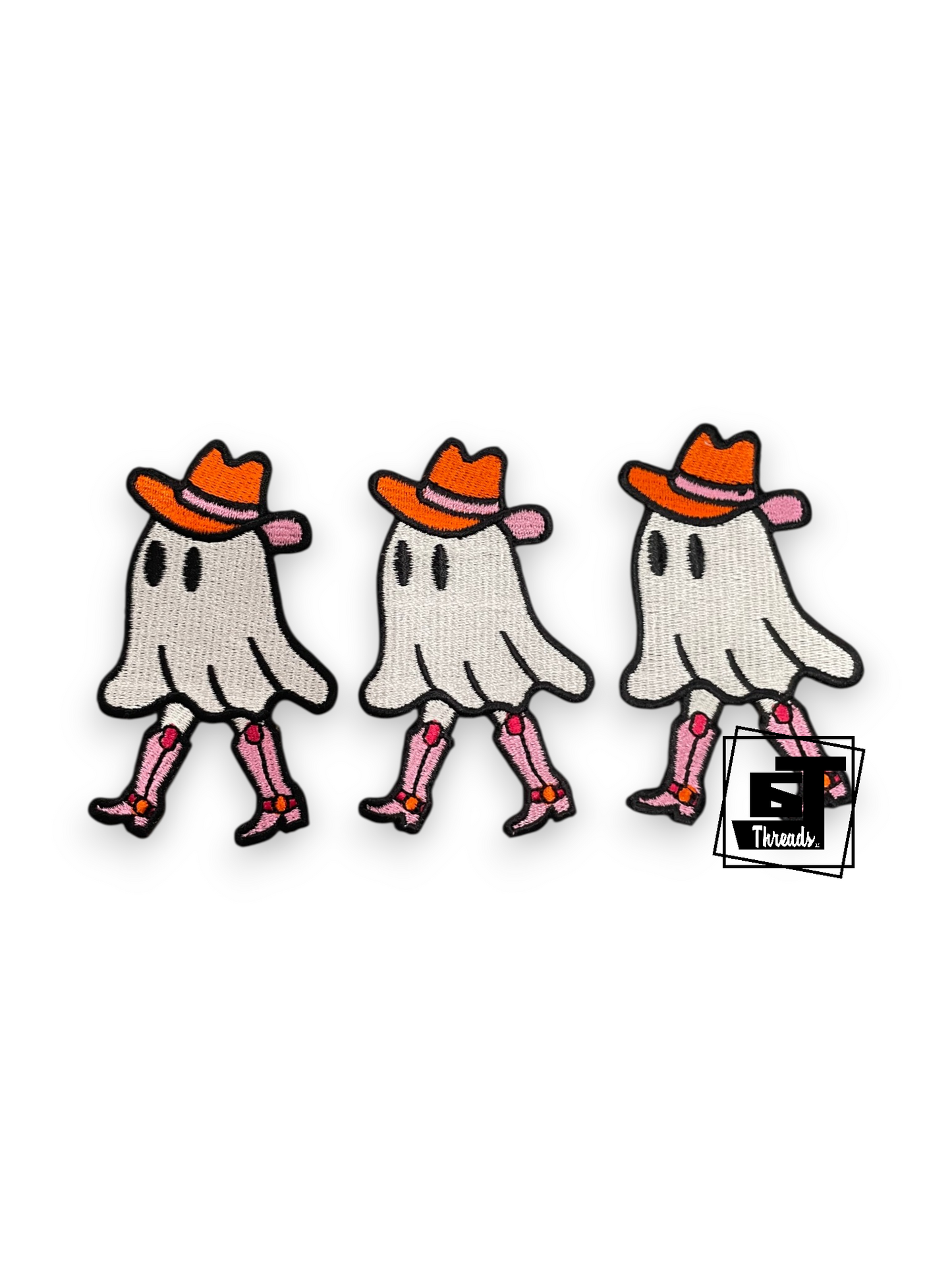 Three identical embroidered ghost patches wearing orange cowboy hats and pink boots, shown on a plain white background with a small 'Trends' logo overlay near the bottom right.