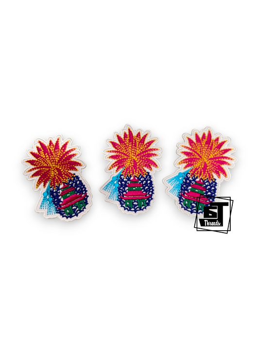 Three identical colorful embroidered patches shaped like stylized pineapples with bright red and yellow tops and blue-purple bodies, shown on a white background with a small black logo in the lower right corner.