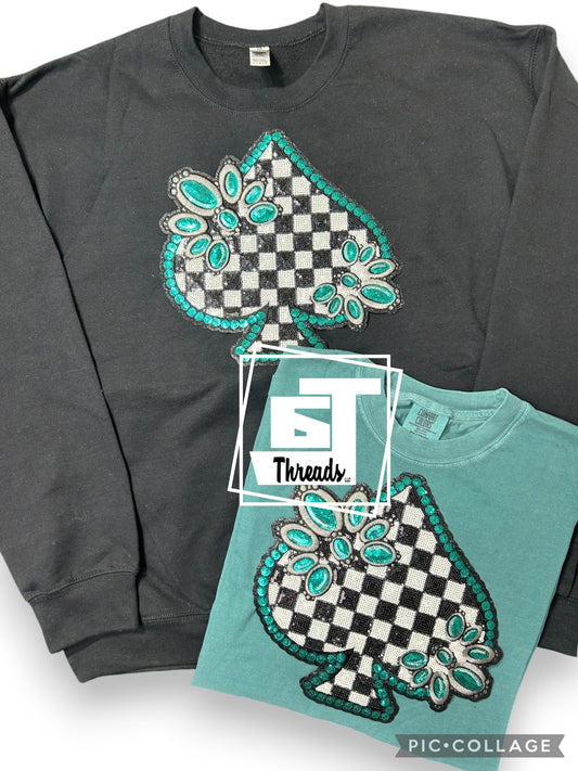 Turquoise spade on a black crewneck 