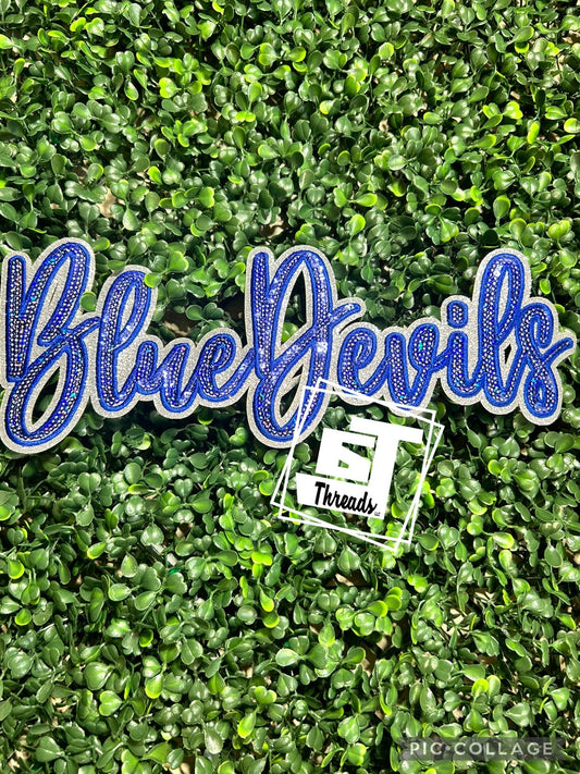 Blue 'Blue Devils' patch with 'ET Threads' logo on a green leafy background
