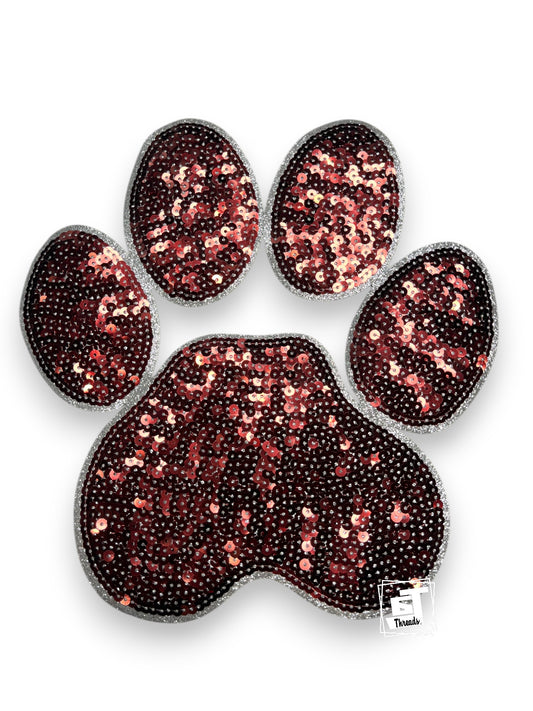 Sequined paw print design on a white background