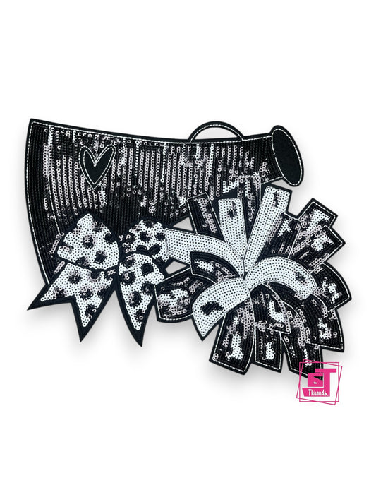 Black and silver sequin hair bow with decorative elements on a white background