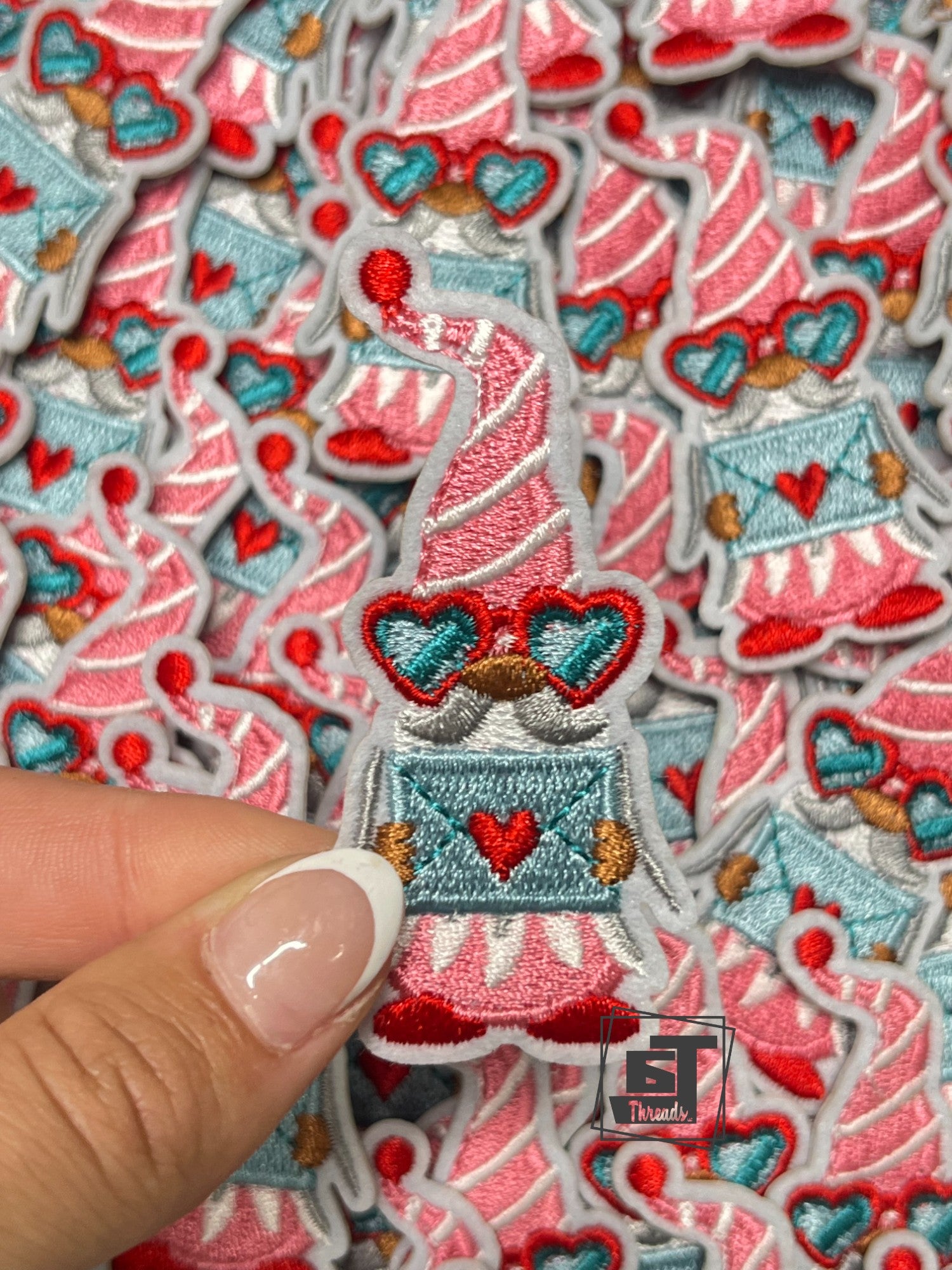 Collection of embroidered patches with festive designs, including a hand holding one patch.