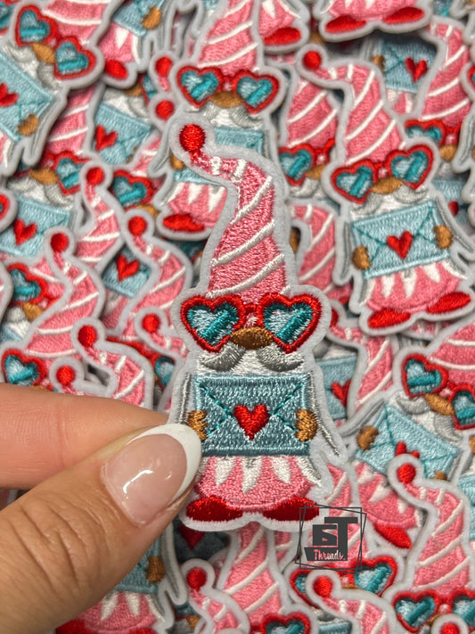 Collection of embroidered patches with festive designs, including a hand holding one patch.