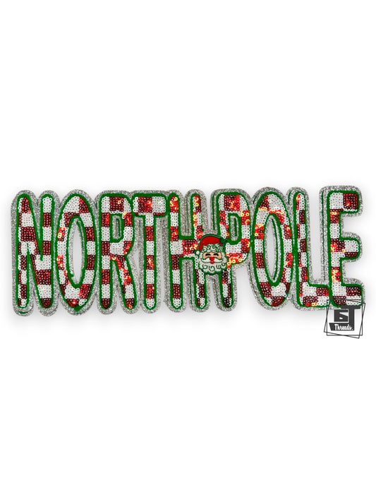 Decorative patch with 'NORTH POLE' text in red, green, and white on a white background