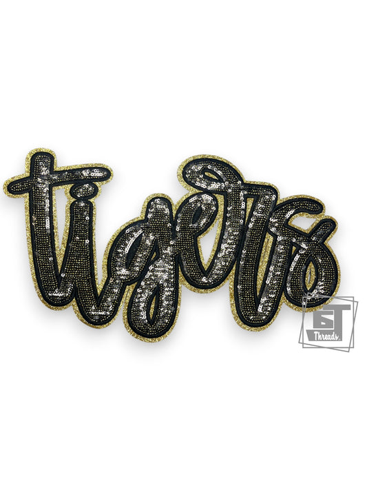 Decorative patch with 'tigers' text in black and gold on a white background