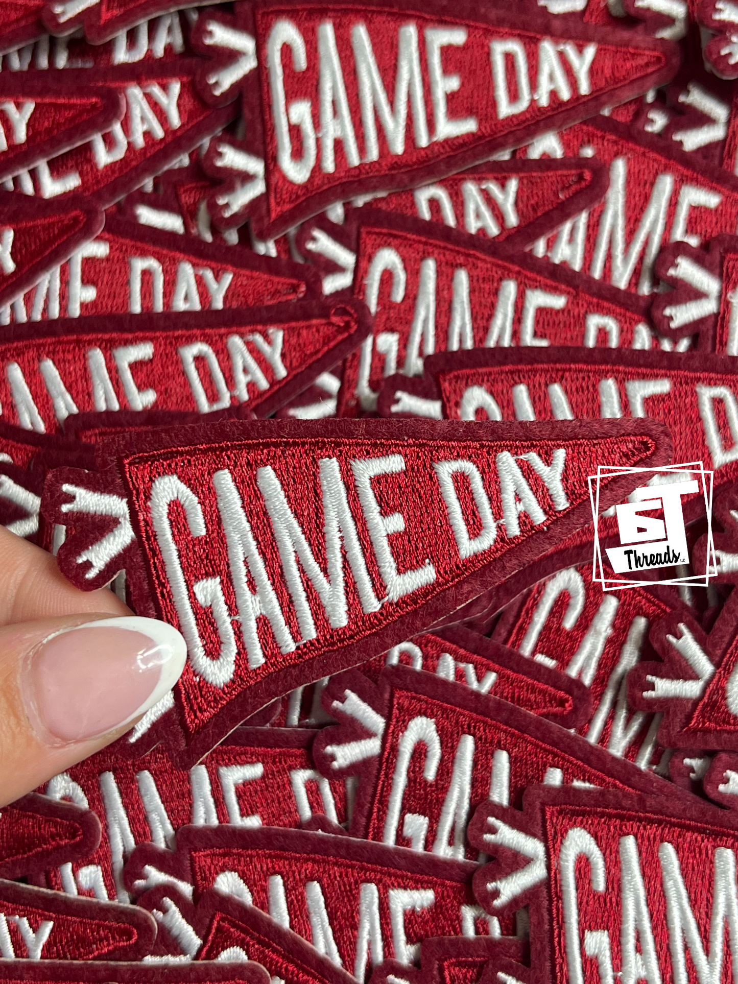 maroon'GAME DAY' patches with a hand holding one, branded 'ST Threads'.
