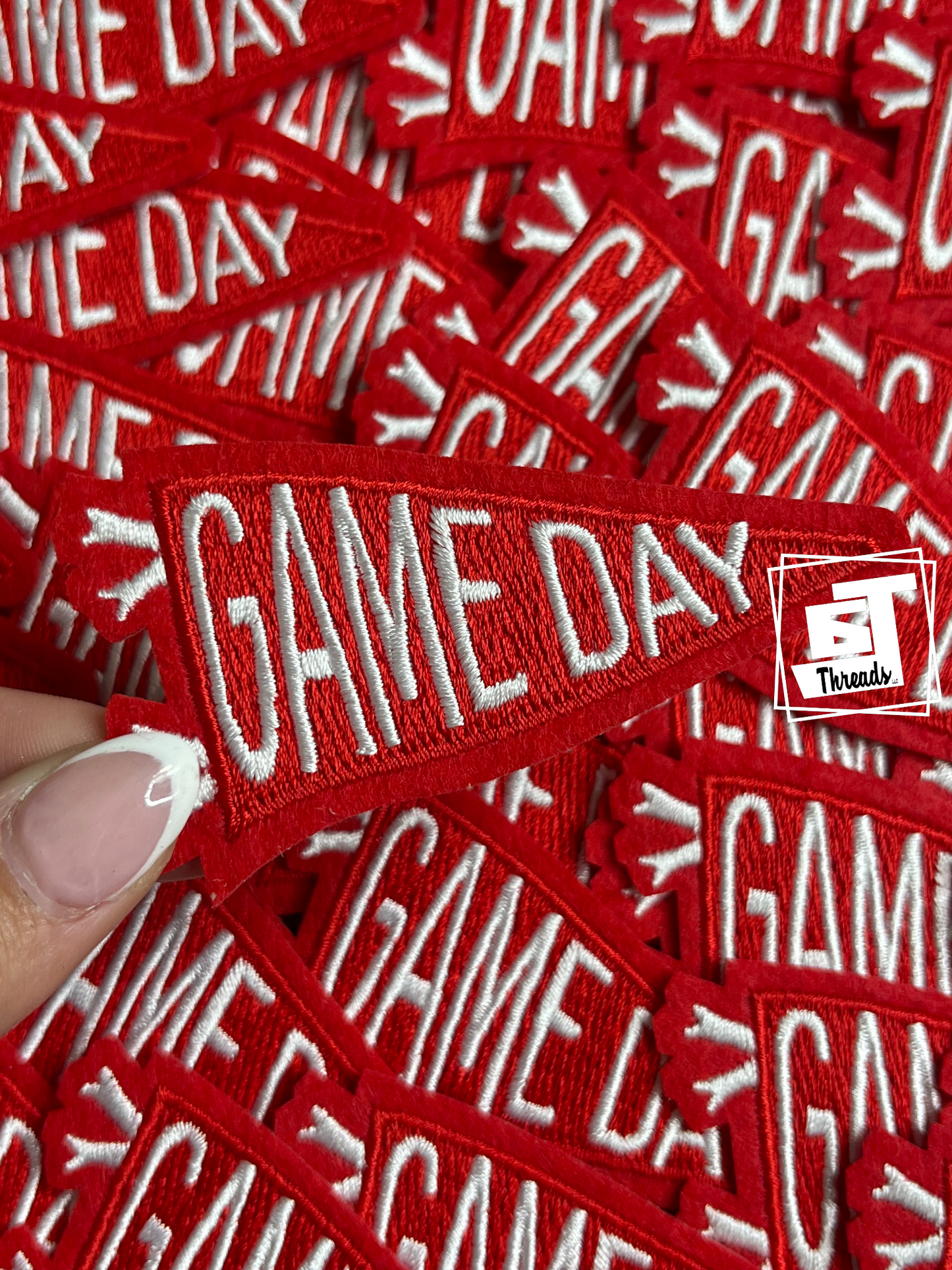 Red 'GAME DAY' patches with a hand holding one, branded 'FT Threads'.