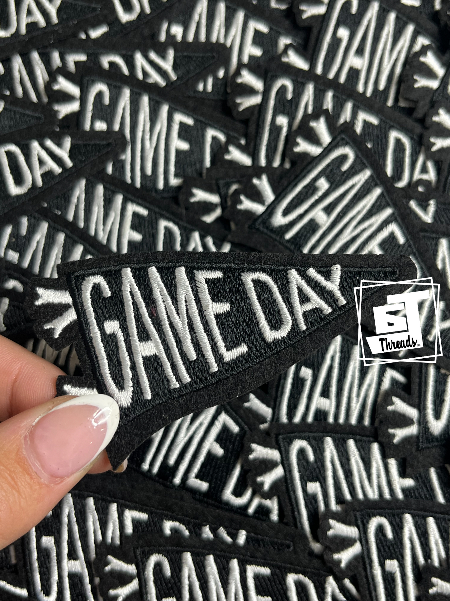 Multiple 'GAME DAY' patches with a hand holding one, branded by 5S Threads.
