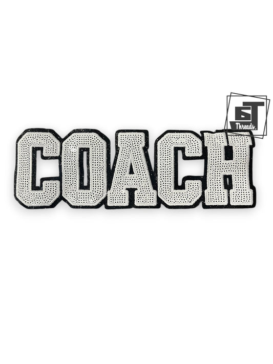 Decorative patch with 'COACH' text and a brand logo on a white background