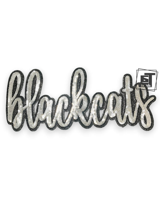 Decorative patch with 'blackcats' text on a white background