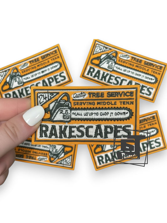 Rakescapes stickers with a hand holding one of them on a white background