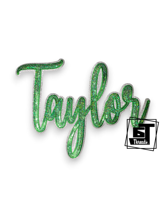 Measurements 10 inches wide by 4.5 inches tall
Angry green sequin duck with black embroidery and black glitter background
Iron-on Patch