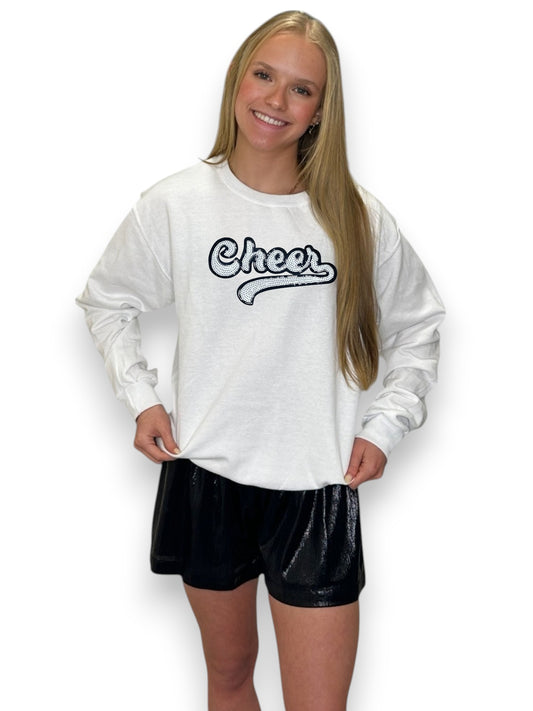 Person wearing a white 'Cheer' sweatshirt and black shorts on a white background