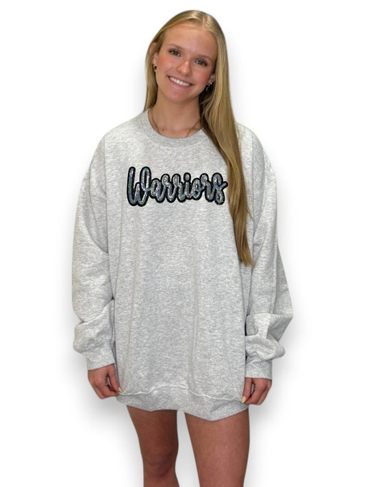 Person wearing a gray sweatshirt with 'Warrior' text on a white background
