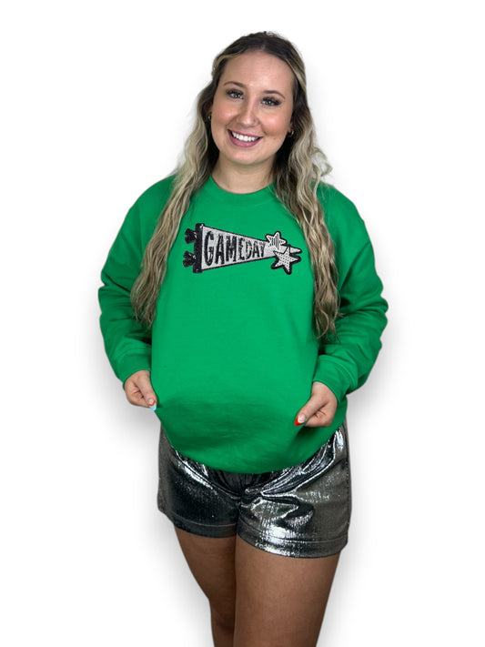 Woman wearing a green sweatshirt with 'Game Day' graphic on a white background