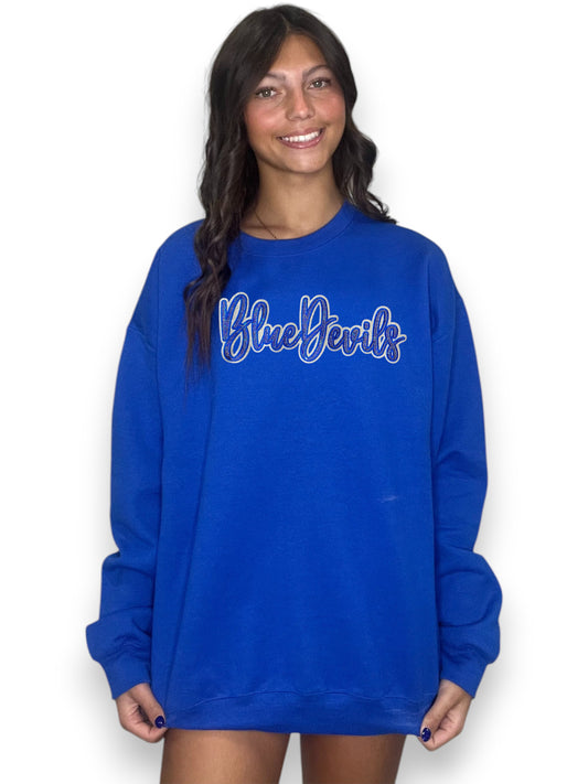 Person wearing a blue sweatshirt with 'Blue Devils' text on a white background