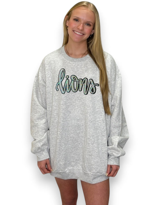 Person wearing a gray sweatshirt with 'Lions' text on a white background