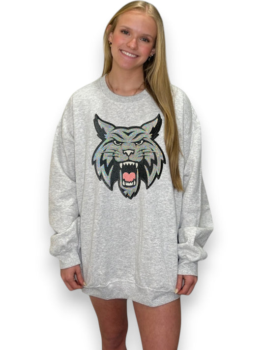 Person wearing a gray sweatshirt with a wolf graphic on a white background