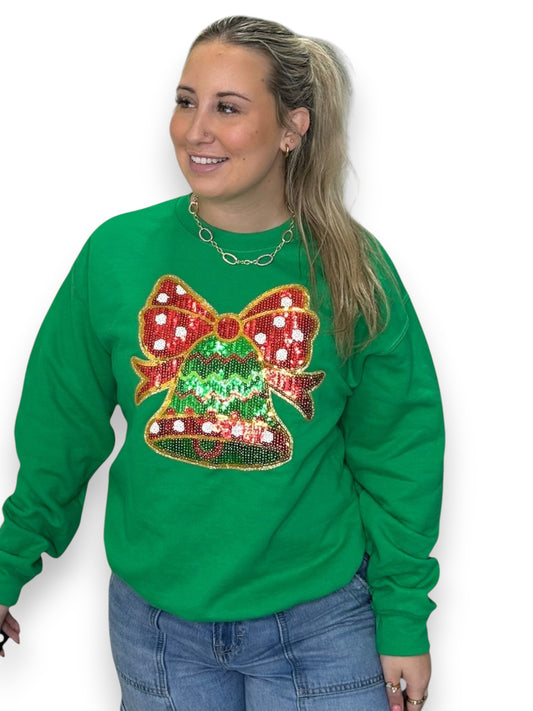 Person wearing a green sweatshirt with a festive design on a white background