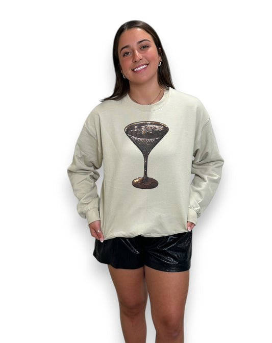 Woman wearing a light green sweatshirt with a martini glass graphic on a white background