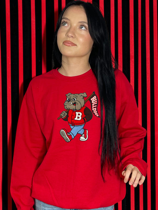 Person wearing a red sweatshirt with a bulldog graphic and 'B' letter on a red and black striped background