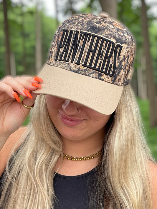 Person wearing a camouflage cap with 'PANTHERS' text in an outdoor setting